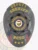An elegant black custom metal badge for deputy sheriffs, featuring a distinct star shape with "DEPUTY SHERIFF" inscribed in bold gold letters at the top. The center displays a circular emblem proclaiming "BARKER COUNTY SHERIFF'S OFFICE," along with "STATE OF OREGON." The badge also features "BCSO" below, adorned with three stars, and includes a practical safety pin attachment for convenience.