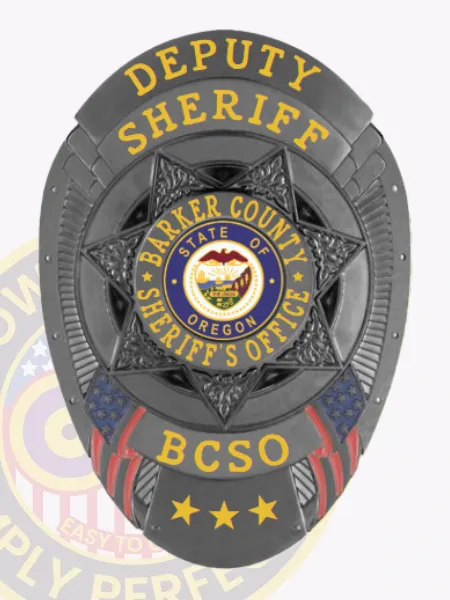 An elegant black custom metal badge for deputy sheriffs, featuring a distinct star shape with "DEPUTY SHERIFF" inscribed in bold gold letters at the top. The center displays a circular emblem proclaiming "BARKER COUNTY SHERIFF'S OFFICE," along with "STATE OF OREGON." The badge also features "BCSO" below, adorned with three stars, and includes a practical safety pin attachment for convenience.