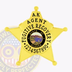 Alaska fugitive recovery agent badge made from gold metal shaped as a 5-point star, with black lettering "ak agent fugitive recovery" around the central state seal and a unique id number beneath, attached with a safety pin backing.