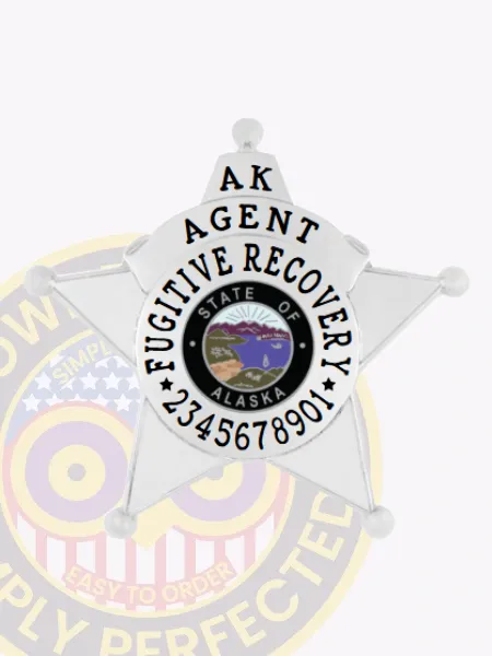 Silver metal 5-point star badge for fugitive recovery agents in Alaska showing "AK AGENT FUGITIVE RECOVERY" in black letters surrounding the official Alaska state emblem, with a numbered code beneath, and attached with a safety pin.