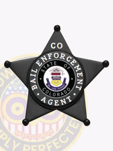 Metal badge in the shape of a black 5 point star for bail enforcement agents, featuring the Colorado state seal in a black and white circle at the center, white lettering around the seal saying "Bail Enforcement Agent," and "CO" on the upper point, designed with a safety pin attachment.
