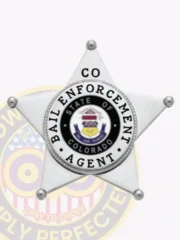 Bail enforcement agent badge shaped as a silver five-pointed star, displaying the Colorado state seal in the center with black and silver detailing, encircled by "Bail Enforcement Agent" text, and "CO" on the top point, made with a safety pin for easy wear.