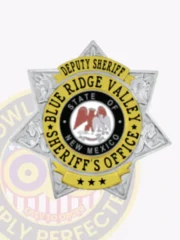 This image presents an elegant silver custom metal badge for deputy sheriffs, centered on a striking 7-point star with gold panels. The text "DEPUTY SHERIFF" arches above the badge, with "STATE OF NEW MEXICO" featured in the center emblem. Designed with a safety pin attachment, this badge combines functionality with authority.