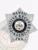 Detailed silver 7 point star badge with raised decorative leaf and scrollwork designs, containing a central black circular emblem that reads "State of Hawaii Fugitive Recovery Agent" surrounding the state seal, and the letters "FRA" on the base, crafted as a custom metal badge with safety pin attachment for fugitive recovery agents in Hawai'i.