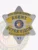 Metal badge in silver with gold panel accents shaped like a 6 point star, featuring blue lettering that reads “BAIL ENFORCEMENT AGENT SUPERVISOR UNITED STATES,” plus the Wisconsin state seal at center, designed for bail enforcement agents with safety pin attachment.