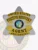 Custom silver 6-point star metal badge with gold panels for fugitive recovery agents in California, featuring black text "UNITED STATES FUGITIVE RECOVERY AGENT" around the colorful California state seal, with an ID number "4567890123" at the bottom and a safety pin attachment.
