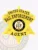 Bail enforcement agent’s custom gold metal 6 point star badge, polished to a bright shine, displaying bold black text on circular banners reading “UNITED STATES BAIL ENFORCEMENT AGENT,” with the Wyoming state seal prominently centered, attached by a safety pin.