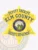 Featuring a classic gold design, this custom metal badge for deputy sheriffs displays "DEPUTY SHERIFF ELM COUNTY" in prominent text at the top. The central round emblem showcases the "STATE OF IDAHO," surrounded by a vibrant blue border. Below, the badge reads "SHERIFF'S DEPARTMENT," and it is equipped with a safety pin attachment for practical use.
