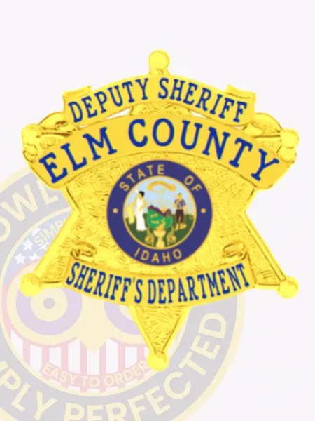 Featuring a classic gold design, this custom metal badge for deputy sheriffs displays "DEPUTY SHERIFF ELM COUNTY" in prominent text at the top. The central round emblem showcases the "STATE OF IDAHO," surrounded by a vibrant blue border. Below, the badge reads "SHERIFF'S DEPARTMENT," and it is equipped with a safety pin attachment for practical use.