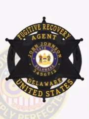 Metal badge featuring a black 6-point star within a circular banner for fugitive recovery agents in Delaware, with bold gold text encircling the badge reading "FUGITIVE RECOVERY AGENT UNITED STATES," the state seal in the middle, personalized "JOHN JOHNSON 3456712," attached via safety pin.