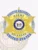 Custom gold 6-point star metal badge with a silver circle banner for fugitive recovery agents in Delaware, featuring blue text "FUGITIVE RECOVERY AGENT UNITED STATES" around the silver circle, a detailed gold star with the Delaware state seal in the center, personalized with "JOHN DOE" and ID number "1234567," complete with a safety pin attachment.