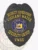 A custom metal badge for a security supervisor, designed in a sleek black finish. The badge prominently displays "SECURITY SUPERVISOR" at the top in bold yellow letters, followed by "VIGILANT WATCH." The central area features a circular emblem representing the state of New York, surrounded by "SECURITY GROUP" and "VWSG." The badge includes decorative eagle wings and is secured with a sturdy safety pin attachment for reliable wear.