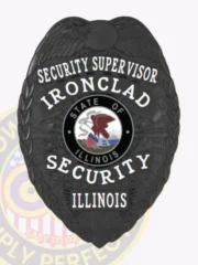 A custom metal badge for a security supervisor, crafted in a sleek black finish. The badge prominently displays "SECURITY SUPERVISOR" at the top in bold white letters, followed by "IRONCLAD." The central area features a circular emblem representing the state of Illinois, surrounded by "SECURITY" and "ILLINOIS." This badge includes decorative eagle wings and is secured with a sturdy safety pin attachment for reliable wear.