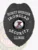 A custom metal badge for a security supervisor, crafted in a sleek black finish. The badge prominently displays "SECURITY SUPERVISOR" at the top in bold white letters, followed by "IRONCLAD." The central area features a circular emblem representing the state of Illinois, surrounded by "SECURITY" and "ILLINOIS." This badge includes decorative eagle wings and is secured with a sturdy safety pin attachment for reliable wear.