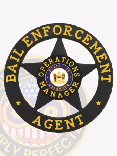 Circular black metal badge for bail enforcement agents, embossed with a five-point star and surrounded by a banner that reads “BAIL ENFORCEMENT AGENT,” including “OPERATIONS MANAGER” and the Delaware state seal in yellow text at the center, designed with a safety pin.