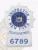 NYPD custom sunburst shield badge designed in sleek silver for the rank of inspector. The bold blue text "INSPECTOR" stands out prominently at the top, surrounding a detailed state emblem in the center. "NEW YORK POLICE DEPARTMENT" curves gracefully beneath, with the badge number "6789" prominently featured at the bottom. This badge includes a practical safety pin attachment for easy and secure fastening.