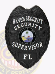 This polished black custom metal badge for security supervisors features "HAVEN SECURITY" boldly displayed at the top in white lettering. Below, "SECURITY SUPERVISOR" and "FL" are featured around a central emblem representing the state of Florida. The badge is adorned with detailed eagle wings and includes a strong safety pin attachment for secure wear.
