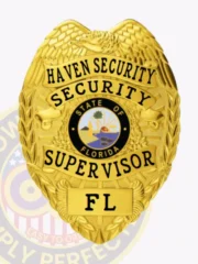 A custom metal badge for a security supervisor, crafted in an eye-catching gold finish. The badge prominently features "HAVEN SECURITY" at the top in bold black letters. Below, "SECURITY SUPERVISOR" is elegantly displayed, surrounding a central circular emblem representing the state of Florida. The badge includes decorative eagle wings and is secured with a sturdy safety pin attachment for reliable wear.