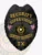 A beautifully designed custom metal badge for security supervisors in black, featuring "SECURITY SUPERVISOR" prominently displayed in yellow letters at the top. Below, "CENTURY SECURITY" and "TX" are inscribed around a circular emblem depicting the Texas state seal. The badge is adorned with intricate eagle wings and small flags, finished with a reliable safety pin attachment for easy wear.