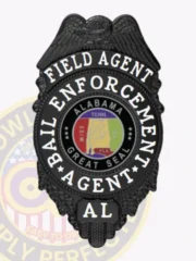 Metal bail enforcement agent badge in black with a detailed eagle at the top, silver lettering including "Field Agent" and "Bail Enforcement Agent" around a colorful Alabama Great Seal, personalized with "AL" and designed with a safety pin backing.