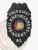 Metal bail enforcement agent badge in black with a detailed eagle at the top, silver lettering including "Field Agent" and "Bail Enforcement Agent" around a colorful Alabama Great Seal, personalized with "AL" and designed with a safety pin backing.
