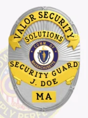 This custom metal badge for security guard features a sleek silver finish complemented by elegant gold panels. The badge prominently displays "VALOR SECURITY" and "SOLUTIONS" at the top in bold yellow lettering, with the state emblem of Massachusetts at the center and "SECURITY GUARD J. DOE" clearly marked below, ensuring a professional appearance.