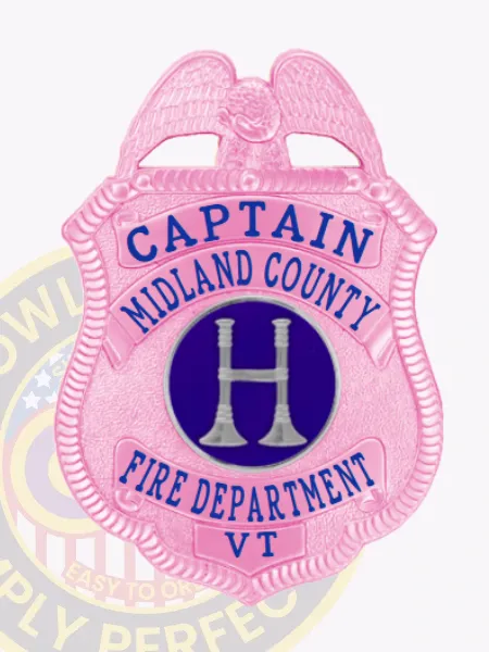 Midland County Fire Dept. captain badge in BCAM pink metal, showing a pink eagle crest above pink scrolls with blue lettering "CAPTAIN," "MIDLAND COUNTY," and "FIRE DEPARTMENT," a central dark blue circle containing a silver fire trumpet emblem, and "VT" on the lower banner.