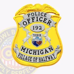 Village of halfway police dept. Gold metal badge featuring a raised eagle emblem atop a bright gold shield, white banners with black text reading "police officer," the number "192" inside a gray oval, silver deer flanking the colorful michigan state seal, and "michigan village of halfway" along the bottom edge, designed with a safety pin attachment for easy use.