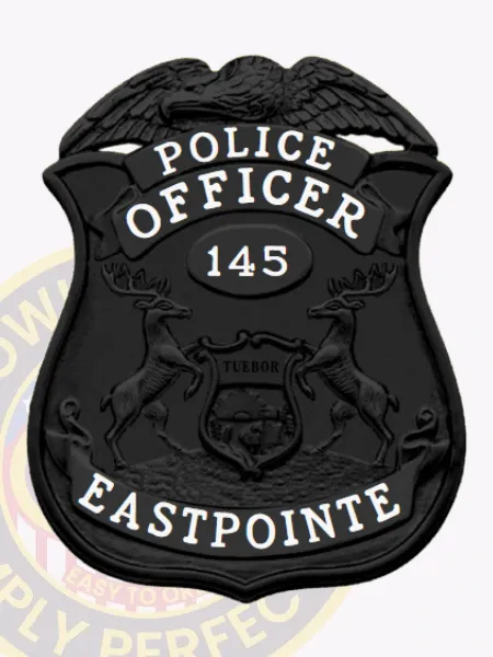 Matte black metal badge with an eagle emblem crowning the shield, displaying white text "POLICE OFFICER" at the top, officer number "145" inside a central oval, and "EASTPOINTE" across the lower section, a custom black eagle top metal badge for Eastpointe Police Dept. equipped with a safety pin for secure attachment.
