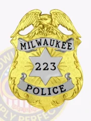 Gold metal badge for Milwaukee Police Department showcasing a raised gold eagle at the top of the shield, silver banners with bold black text MILWAUKEE and POLICE, and a silver star with the number 223 engraved in the center, designed with a safety pin attachment.