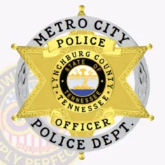 Detailed gold six-point star badge framed by a silver circle featuring bold black lettering "metro city police dept. " around the edge, highlighting the tennessee state seal and lynchburg county text, with two gold banners on the star displaying "police" and "officer," attached with a safety pin.