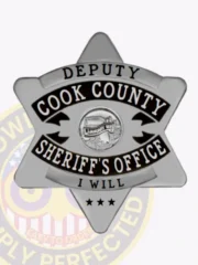 Cook County sheriff's office deputy metal badge in silver six-point star shape, black enamel lettering, central Illinois state seal, three black stars on lower point, and safety pin closure