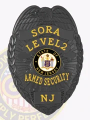 Custom black metal badge with raised eagle at the top, bright gold letters reading SORA LEVEL2 ARMED SECURITY NJ around the New Jersey state seal, equipped with a safety pin for fastening.