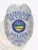 Custom Seville Police Dept. Patrolman badge made of polished silver metal featuring an eagle at the shield’s top, blue text PATROLMAN, SEVILLE, and POLICE on scrolls, a multi-color State of Ohio emblem in the center, and the number 8810 at the base, attached with a safety pin.