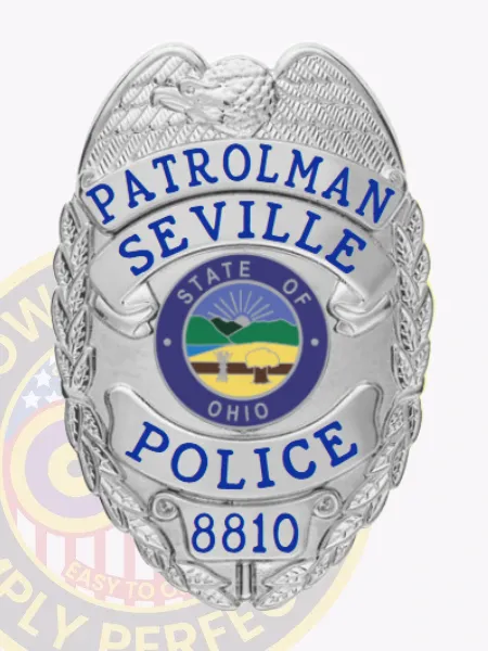 Custom Seville Police Dept. Patrolman badge made of polished silver metal featuring an eagle at the shield’s top, blue text PATROLMAN, SEVILLE, and POLICE on scrolls, a multi-color State of Ohio emblem in the center, and the number 8810 at the base, attached with a safety pin.