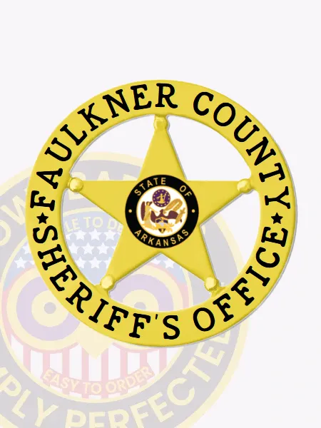 Gold five-point star metal badge encircled by a gold banner displaying Faulkner County Sheriff’s Office in bold black text and a central State of Arkansas seal, featuring a safety pin closure