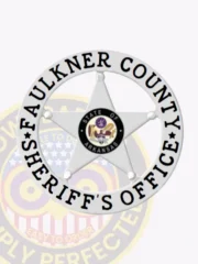 Custom silver 5 point star metal badge with a circular white banner for Faulkner County sheriff's office, featuring black text and the Arkansas state emblem, attached with a safety pin.