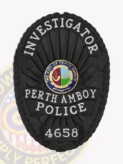 Oval-shaped black custom metal badge for Perth Amboy police investigators, displaying "INVESTIGATOR" at the top in white lettering, the official Perth Amboy city seal in full color in the middle, "PERTH AMBOY POLICE" in strong white font underneath, and badge number "4658" at the base, framed by a leaf-patterned edge and equipped with a safety pin attachment.
