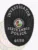 Oval-shaped black custom metal badge for Perth Amboy police investigators, displaying "INVESTIGATOR" at the top in white lettering, the official Perth Amboy city seal in full color in the middle, "PERTH AMBOY POLICE" in strong white font underneath, and badge number "4658" at the base, framed by a leaf-patterned edge and equipped with a safety pin attachment.