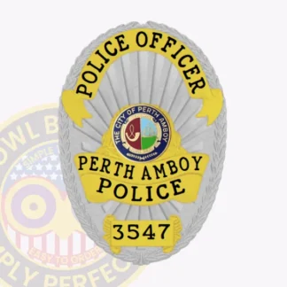 Oval custom silver metal badge for Perth Amboy police officer, featuring black text on yellow ribbons reading "POLICE OFFICER" at the top, "PERTH AMBOY POLICE" in the center, and "3547" on the lower plate, surrounding the multicolor official city seal on a shiny silver base with leaf embossing around edges, equipped with a safety pin attachment.