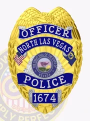 North Las Vegas Police officer badge made of gold metal with an eagle crest at the top, accented by blue reverse enamel banners stating Officer, North Las Vegas, Police, and badge number 1674, surrounding the official Nevada state seal, including a safety pin fastener.
