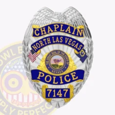 Detailed silver metal badge featuring a raised eagle crest and four blue reverse enamel panels displaying chaplain, north las vegas, police, and 7147 in gold font, incorporating the great seal of nevada in the middle, designed for north las vegas police chaplains with a safety pin backing.