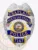 Metal badge in silver color featuring an eagle at the top and blue reverse enamel sections showing Chaplain, North Las Vegas, Police, and badge number 7147, with the Nevada state seal in the center, created for the North Las Vegas Police chaplain position with a safety pin for secure wear.