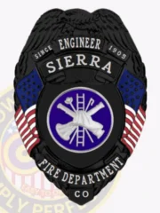 Matte black custom engineer badge for Sierra fire department, eagle on top, white lettering on black ribbons surrounding American flags and a navy circle with silver firefighting equipment in the center, designed with a safety pin closure.