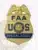 Alt text: Front view of a custom gold eagle top metal badge for FAA, the special agent with safety pin attachment, displaying a shiny gold eagle on top of a shield-shaped badge with bold blue "FAA U S" text and the official FAA seal, plus a blue banner stating "SPECIAL AGENT."