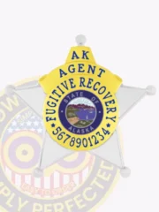 Silver and gold 5-point star badge designed for Fugitive Recovery agents in Alaska, displaying the State of Alaska seal in the middle, surrounded by bold blue lettering and an ID number, secured with a safety pin on the back.