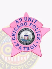 Close-up of a bright pink metal 5-point star badge for the Chicago Police K9 Unit, with blue lettering and the official Chicago city seal in the center, equipped with a safety pin for secure fastening.