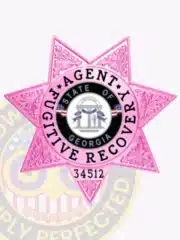 Custom BCAM pink 7-point star metal badge for fugitive recovery agents featuring the Georgia state seal in the center, with safety pin attachment on the back.