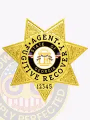 Close-up of a custom gold 7-point star badge for fugitive recovery agents, engraved with intricate patterns, Georgia state seal in the center, and ID number 12345, equipped with a safety pin attachment.