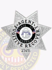 Silver metal badge in a seven-point star shape designed for fugitive recovery agents, displaying the words 'Agent Fugitive Recovery' around the Georgia state emblem, and secured by a safety pin fastener.